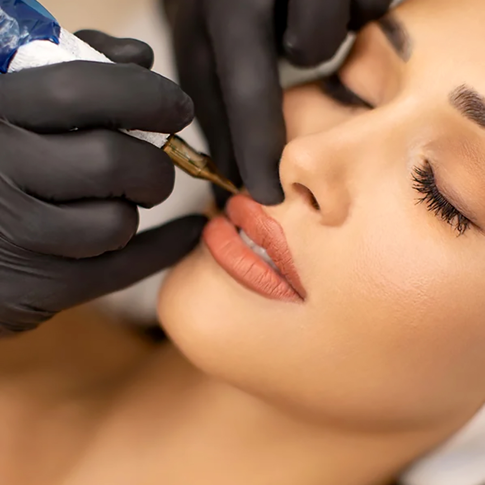 Woman undergoing medical tattooing on her lips for a natural look at a cosmetic clinic.