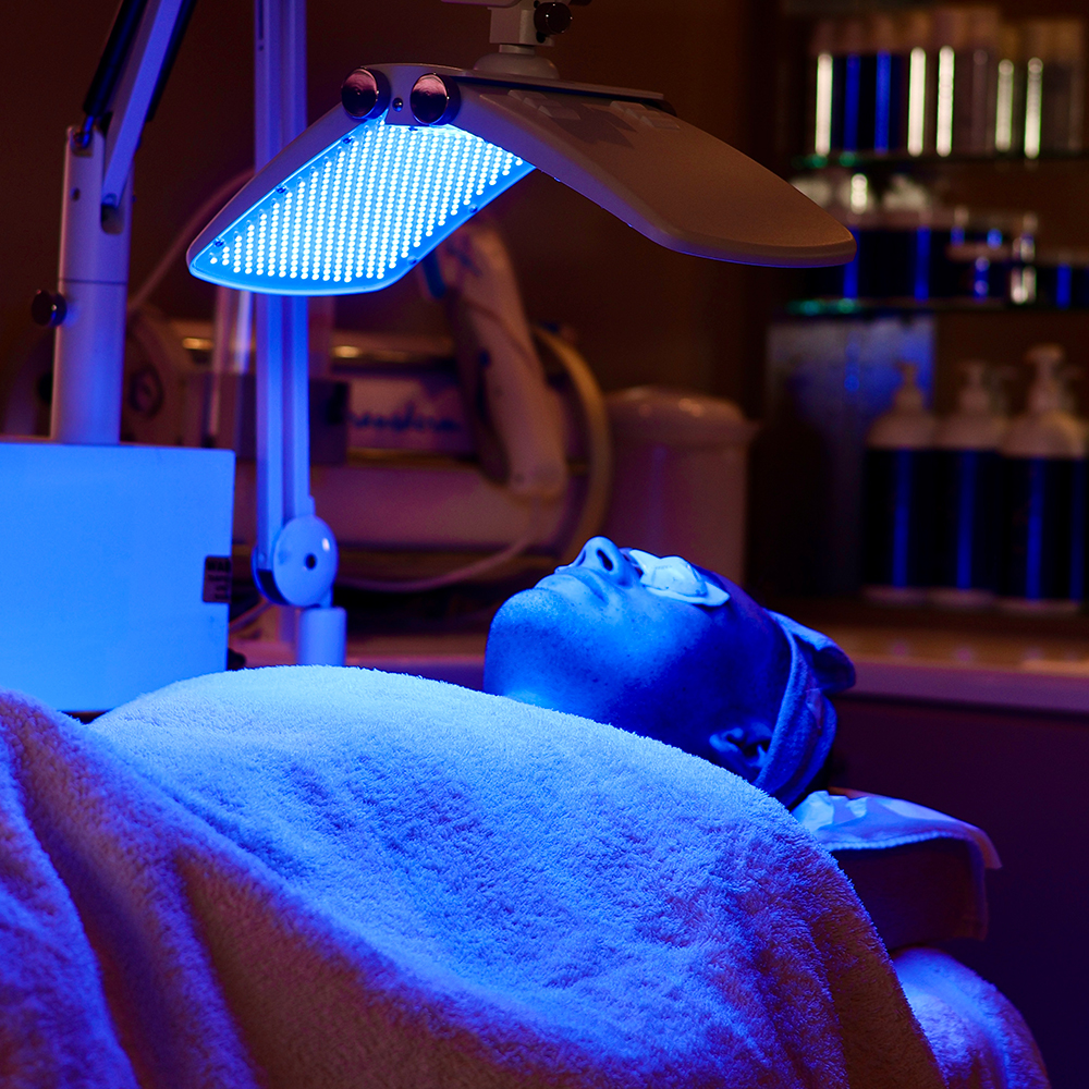 Male patient receiving blue LED light therapy at Janine's Skin & Laser Clinic.