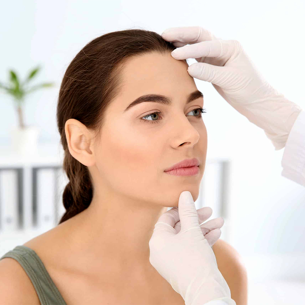 Woman undergoing a thorough examination by an aesthetician before Dermoelectroporation treatment